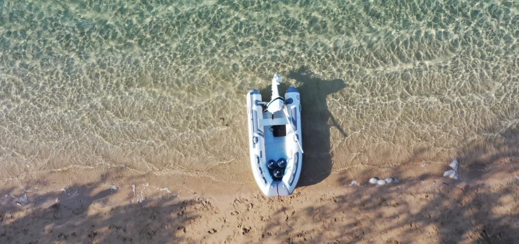 Inflatable boat on shallow beach water