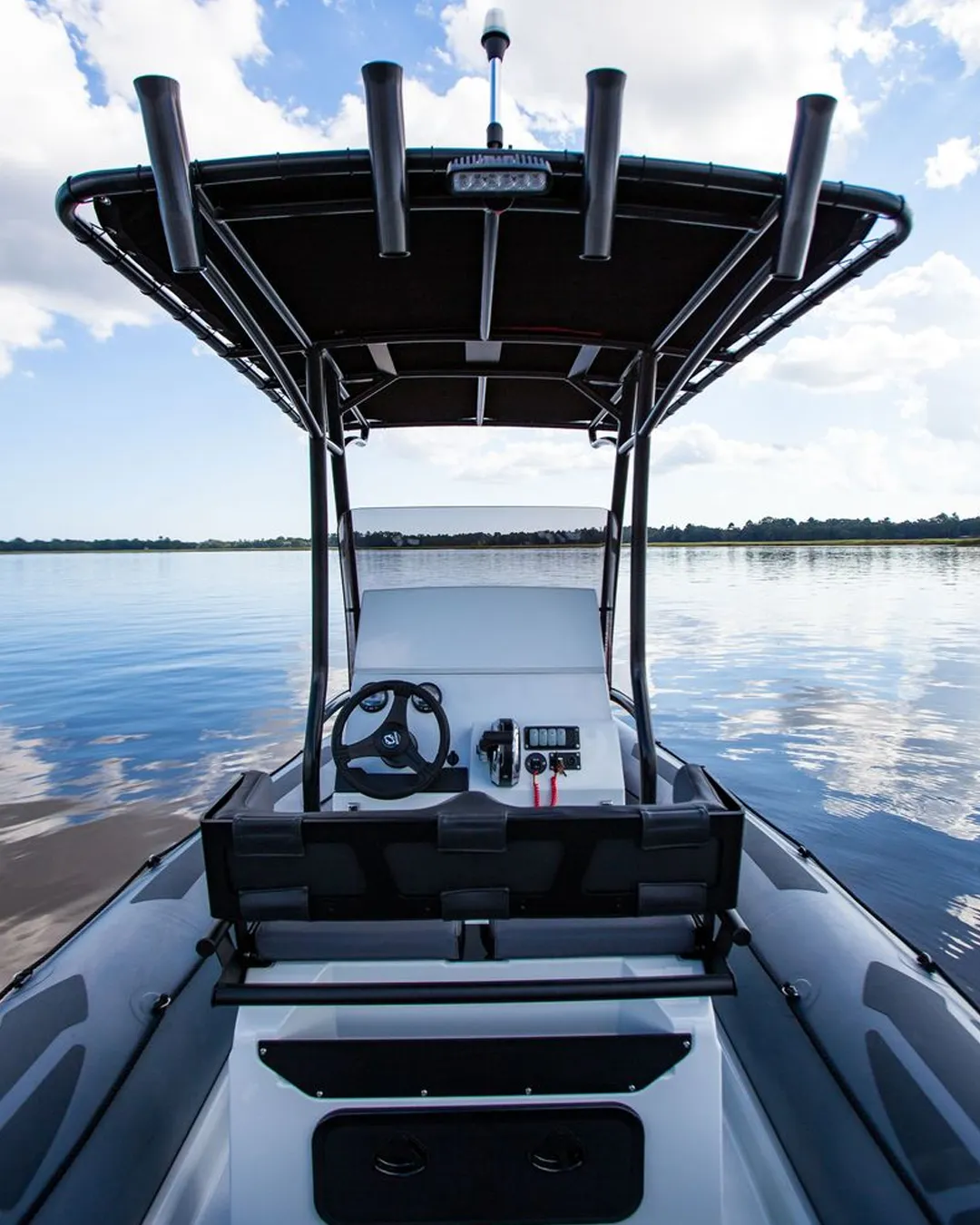 Close view of Zodiac inflatable boat steering console with wheel and controls on the water